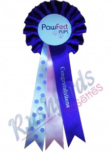 -9cm Head with 20cm long Tails-
1 Row/Tier Rosettes usually are a 2/3 colour item with 1 ribbon printing.
printing is done usually on the front ribbon extra tails can also be added.
2 ribbon printing can be done at extra cost.
Specials such as in the display picture can also be added to give the rosette a personalized touch at an extra cost.